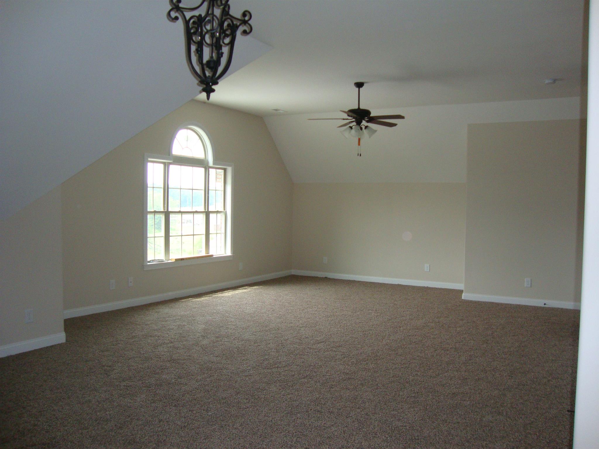 3596 Drake Road Adams, TN 37010 - Photo 2 of 25 an empty room with windows and fan