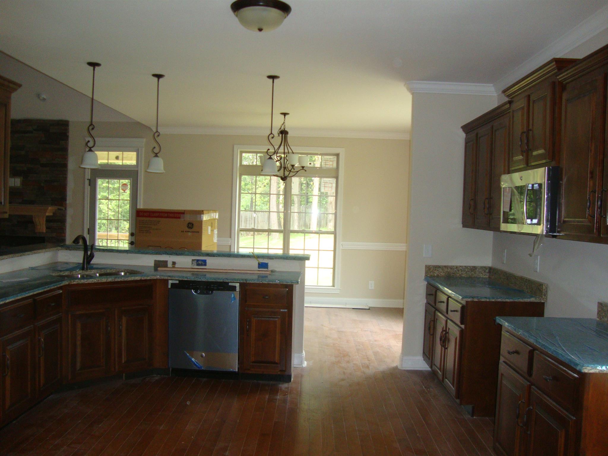 3596 Drake Road Adams, TN 37010 - Photo 21 of 25 a kitchen with kitchen island granite countertop a sink appliances and cabinets
