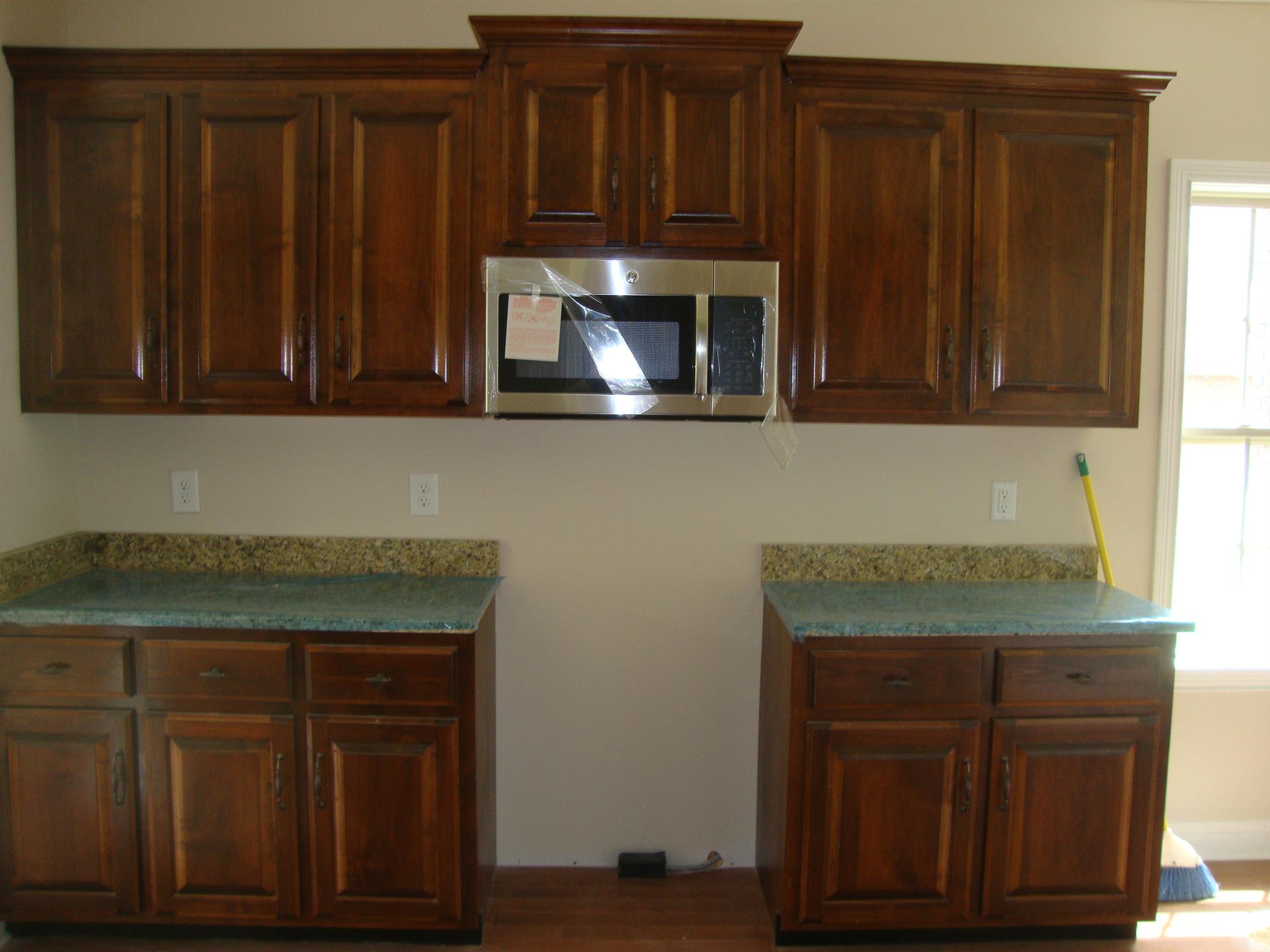 3596 Drake Road Adams, TN 37010 - Photo 22 of 25 a kitchen with granite countertop wooden cabinets a sink and dishwasher