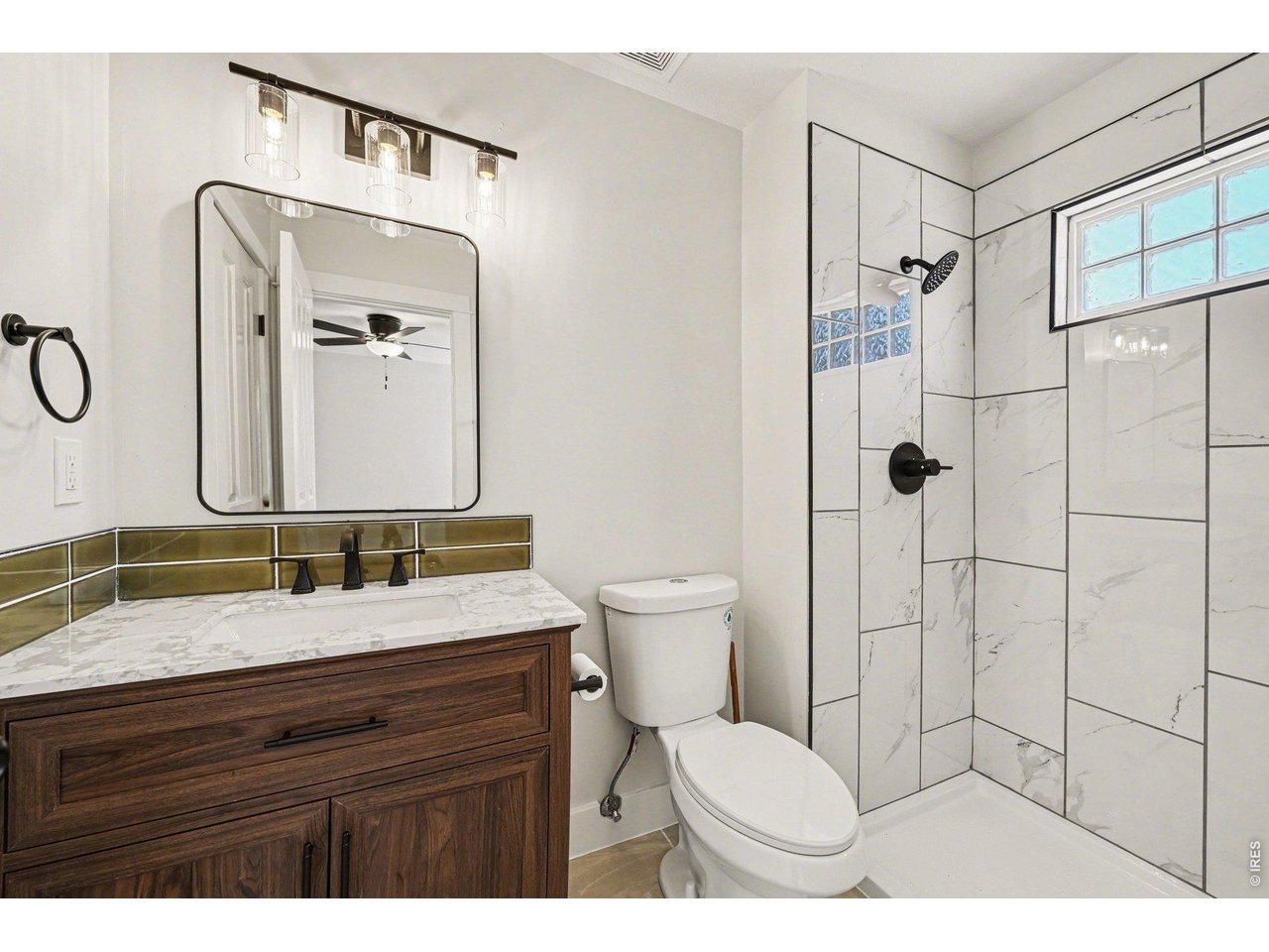 915 Pear Street Fort Collins, CO 80521 - Photo 16 of 20 a bathroom with a granite countertop sink toilet and shower