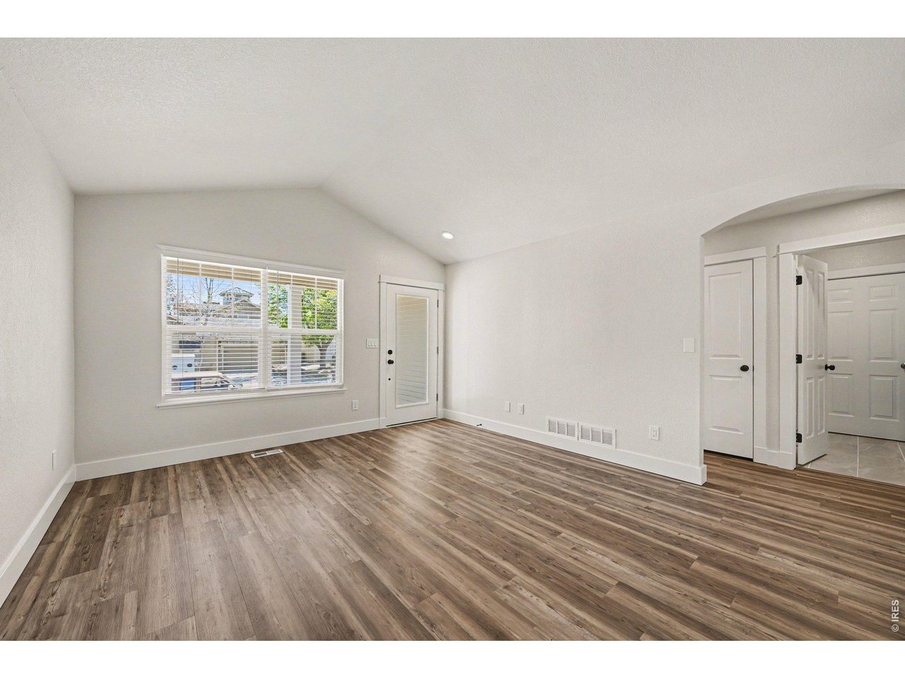 915 Pear Street Fort Collins, CO 80521 - Photo 3 of 20 an empty room with wooden floor and windows