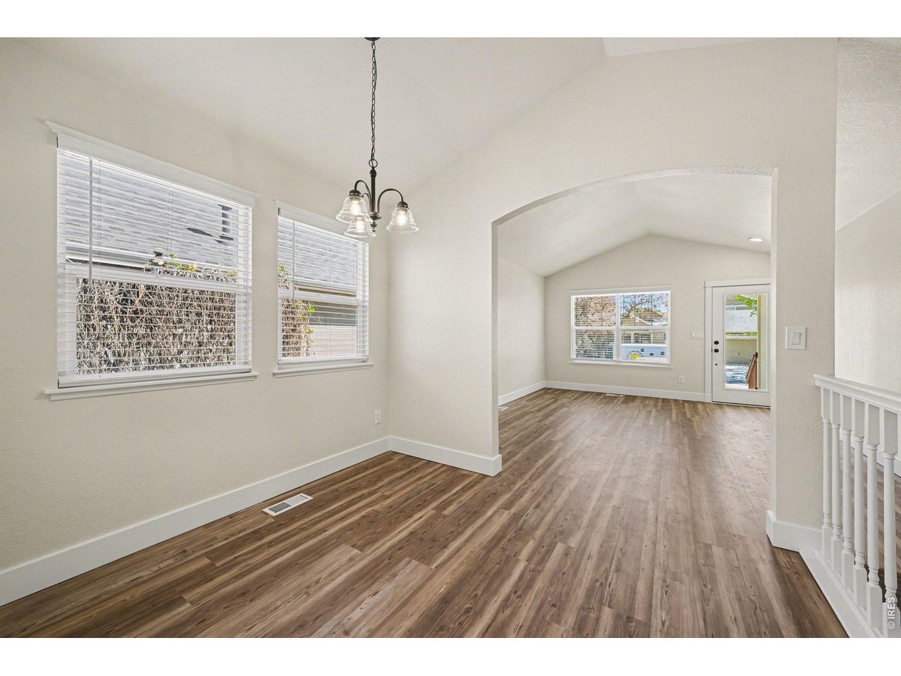 915 Pear Street Fort Collins, CO 80521 - Photo 4 of 20 an empty room with wooden floor and windows