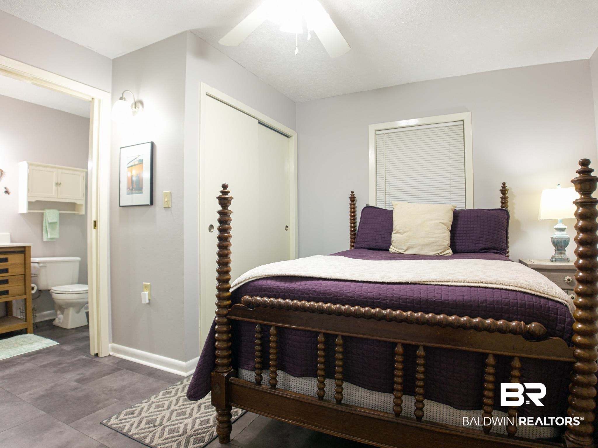 1563 Valencia Drive Lillian, AL 36549 - Photo 12 of 27 Bedroom featuring a closet, connected bathroom, and a ceiling fan