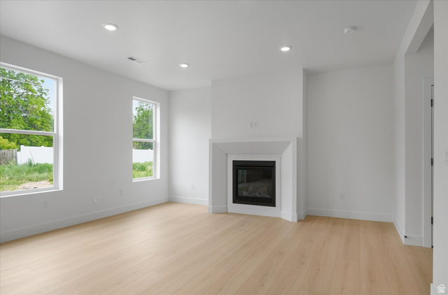 844 North 400 West Logan, UT 84321 - Photo 6 of 43 Living space featuring light wood-finish flooring, recessed lighting, and a contemporary fireplace with a clean-lined mantel