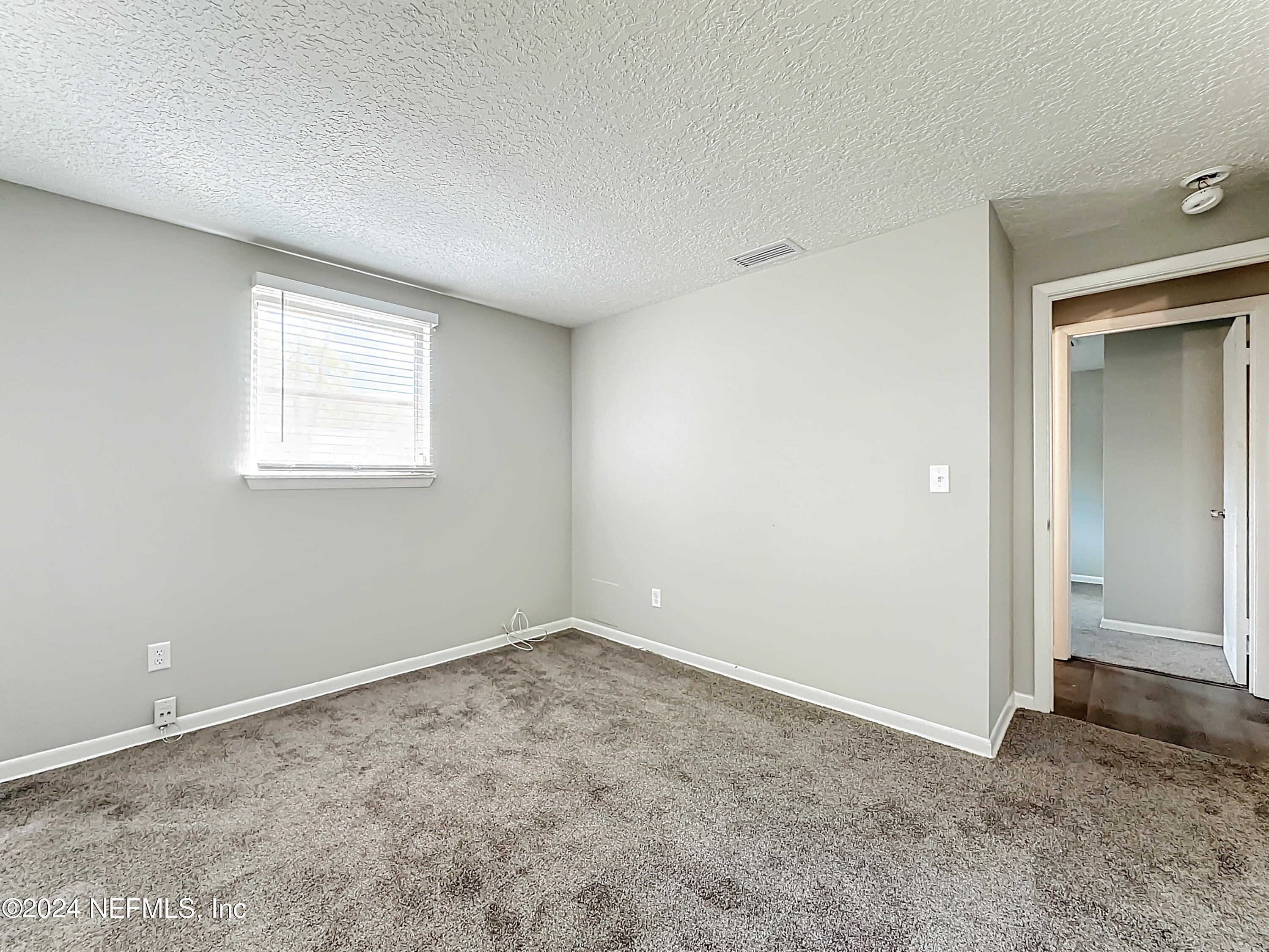242 Shores Boulevard St. Augustine, FL 32086 - Photo 19 of 42 an empty room with a window