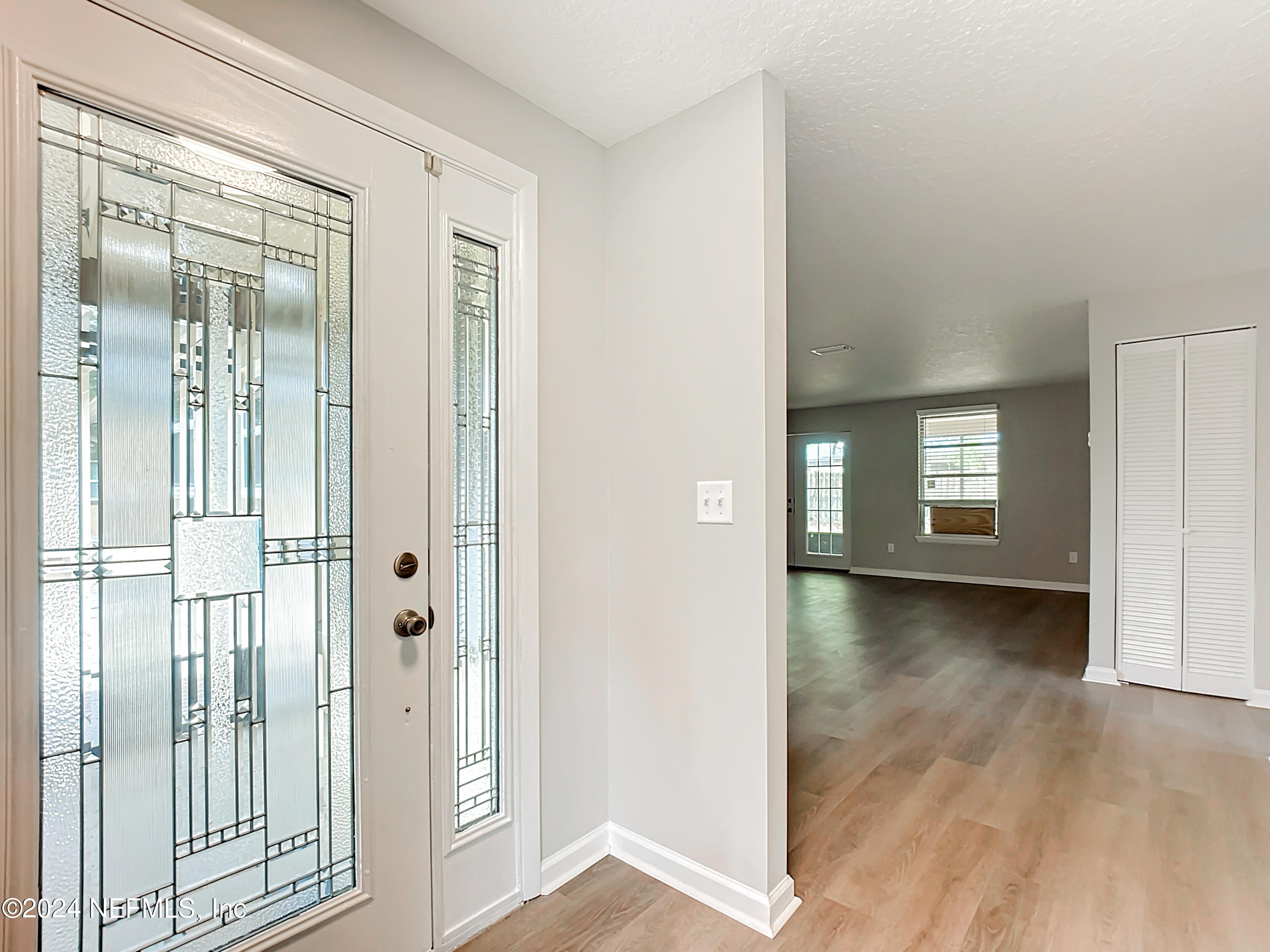 242 Shores Boulevard St. Augustine, FL 32086 - Photo 6 of 42 a view of a hallway with wooden floor and closet area
