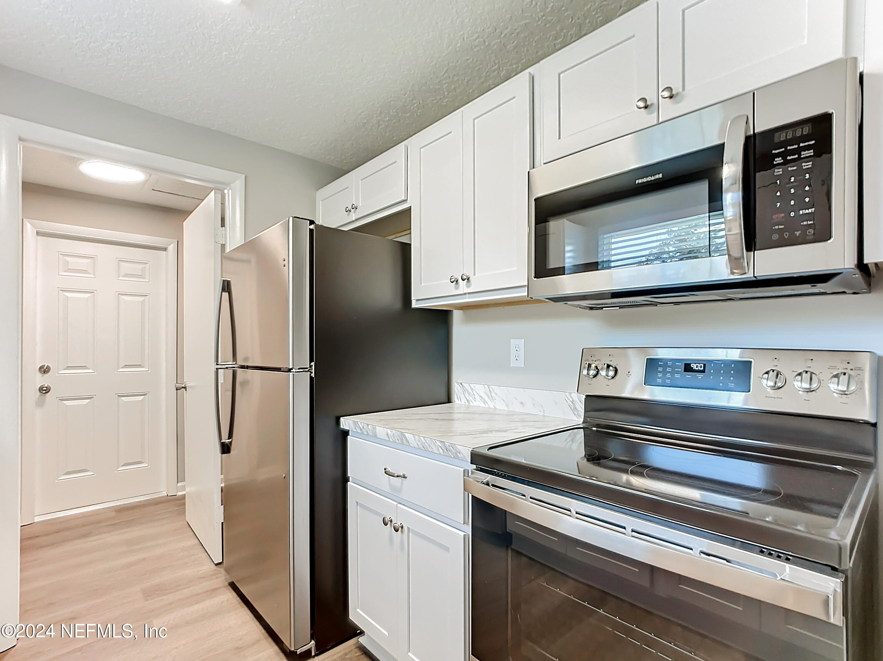 242 Shores Boulevard St. Augustine, FL 32086 - Photo 8 of 42 a kitchen with stainless steel appliances granite countertop a refrigerator stove and cabinets