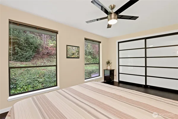 a bedroom with a bed and a large window