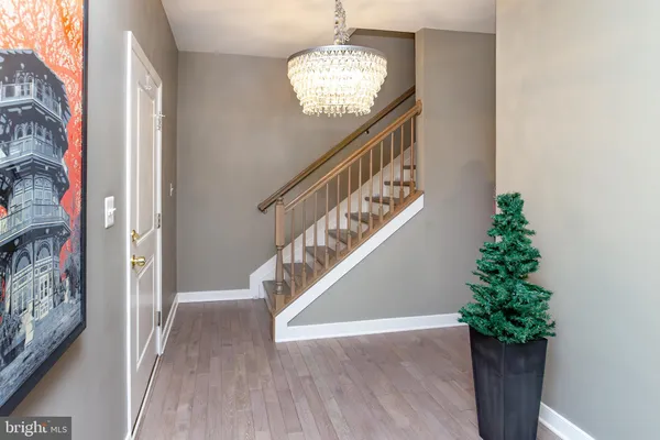 a view of entryway and hall with wooden floor