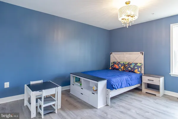 a bedroom with a bed and a chandelier