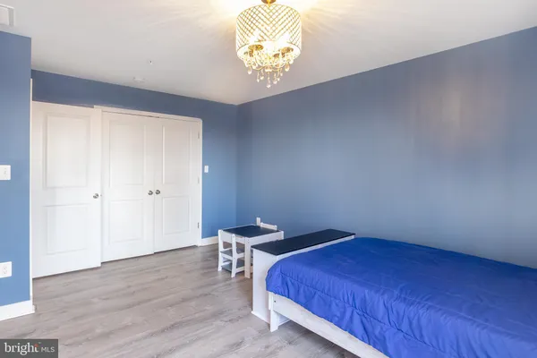 a bedroom with a bed and a chandelier