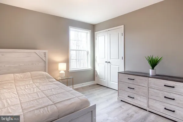 a bedroom with a bed and a dresser