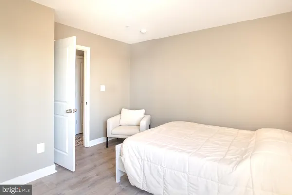 a bedroom with a bed and a night stand
