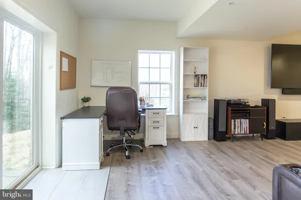 a view of a workspace with furniture and a window