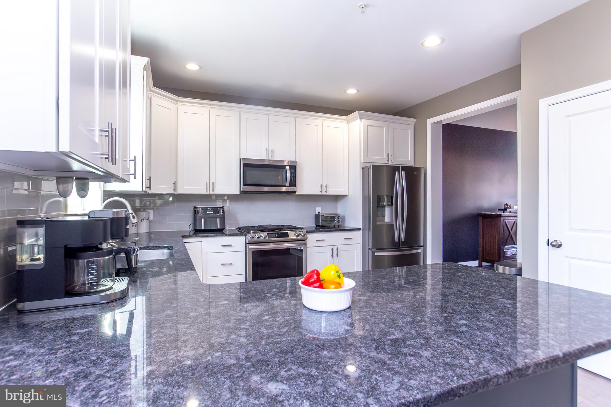 1362 Rock Ridge Road Jarrettsville, MD 21084 - Photo 6 of 50 a kitchen with stainless steel appliances granite countertop a sink a stove a refrigerator a microwave a counter top space and cabinets