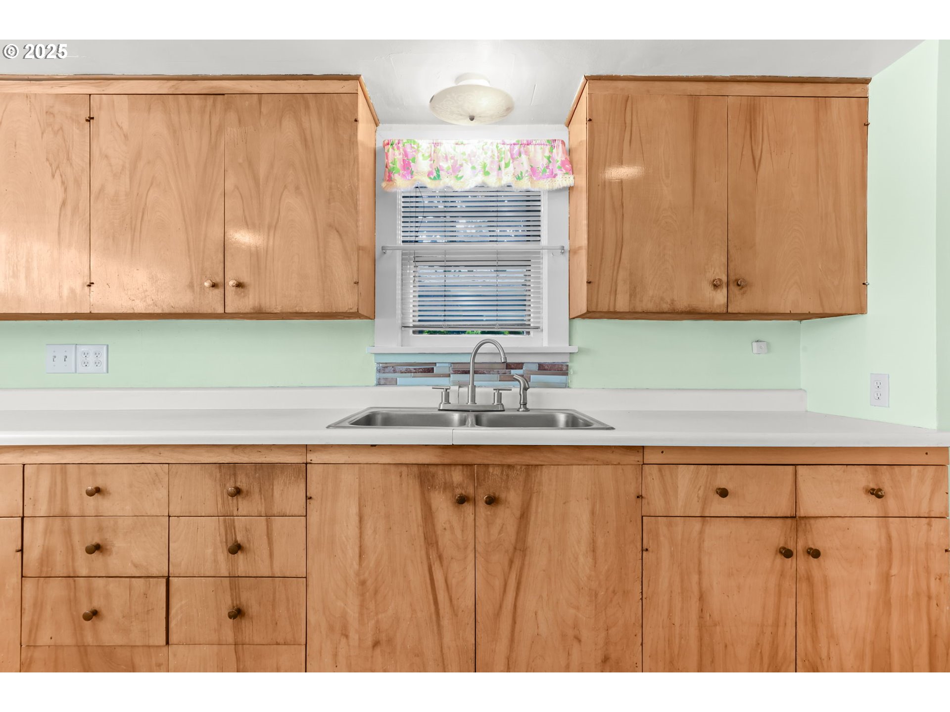 8233 Northeast Tillamook Street Portland, OR 97220 - Photo 16 of 46 a kitchen with granite countertop a sink cabinets and a wooden floor