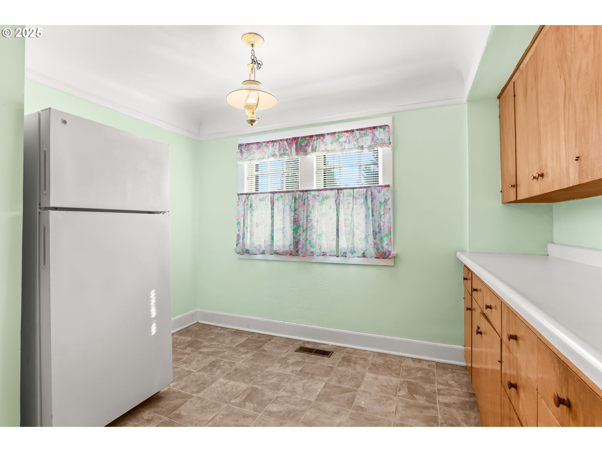 8233 Northeast Tillamook Street Portland, OR 97220 - Photo 17 of 46 a kitchen with a refrigerator and cabinets