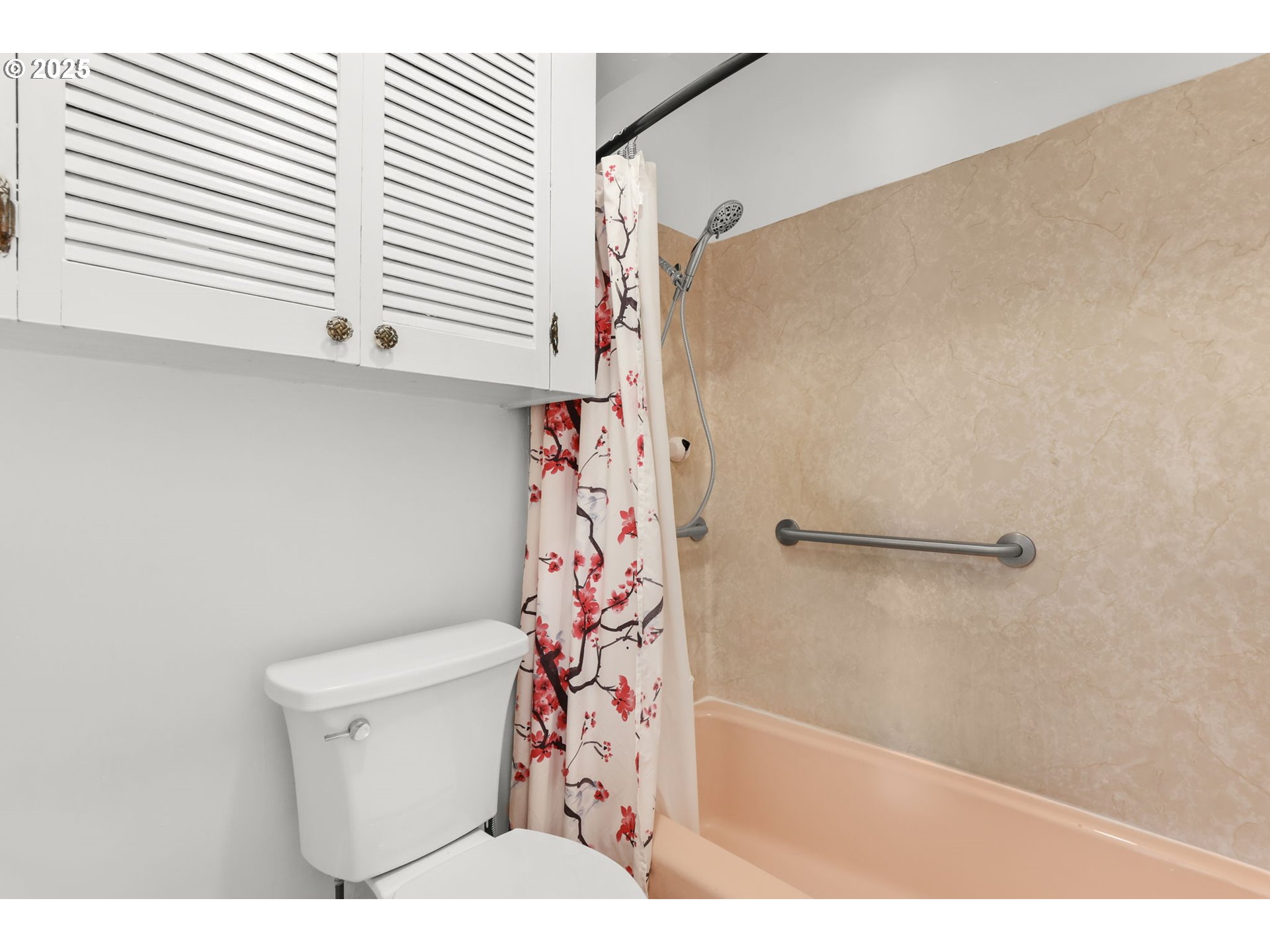 8233 Northeast Tillamook Street Portland, OR 97220 - Photo 23 of 46 a bathroom with a shower curtain and a toilet