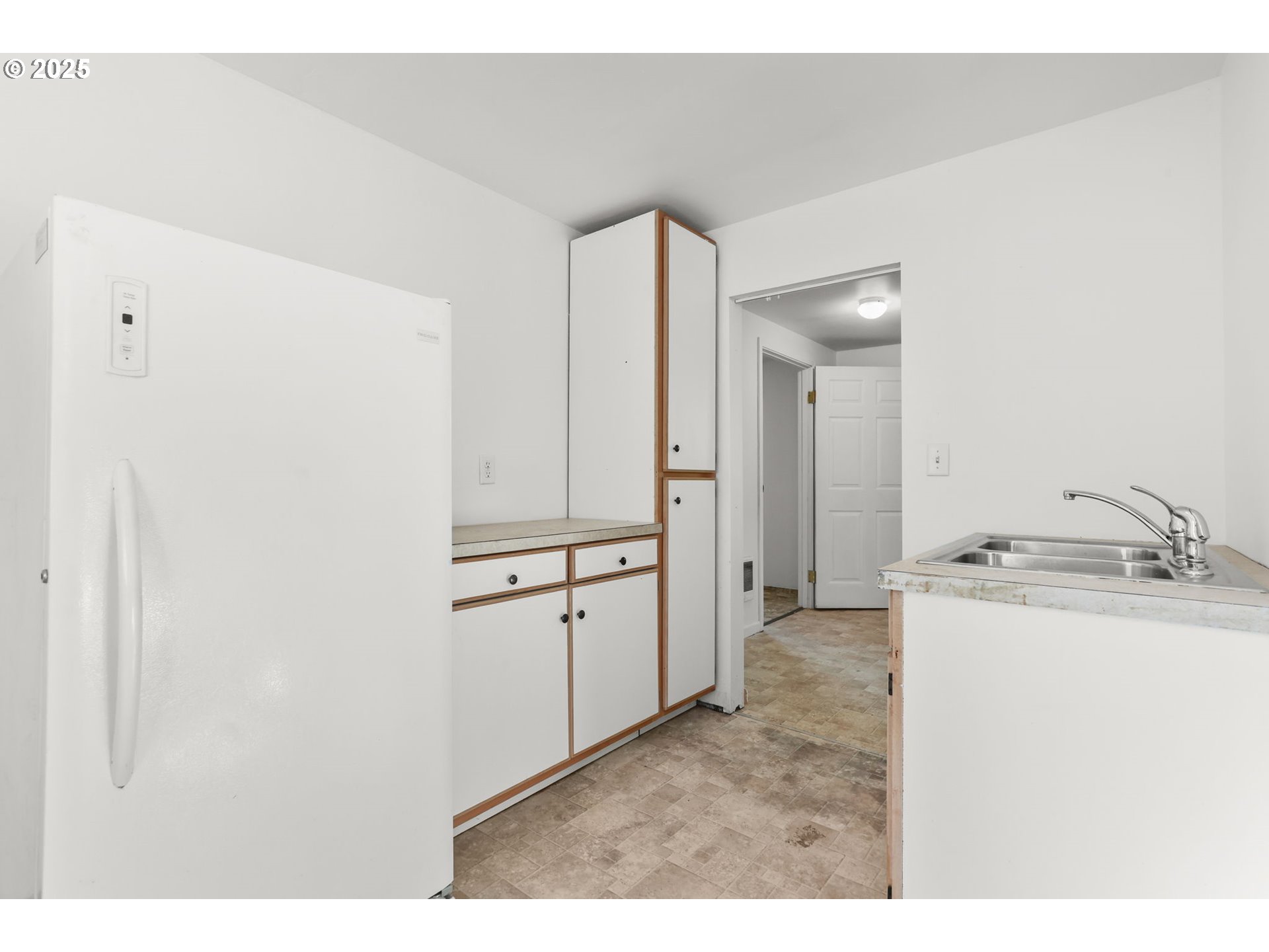 8233 Northeast Tillamook Street Portland, OR 97220 - Photo 36 of 46 a kitchen with a refrigerator and a sink