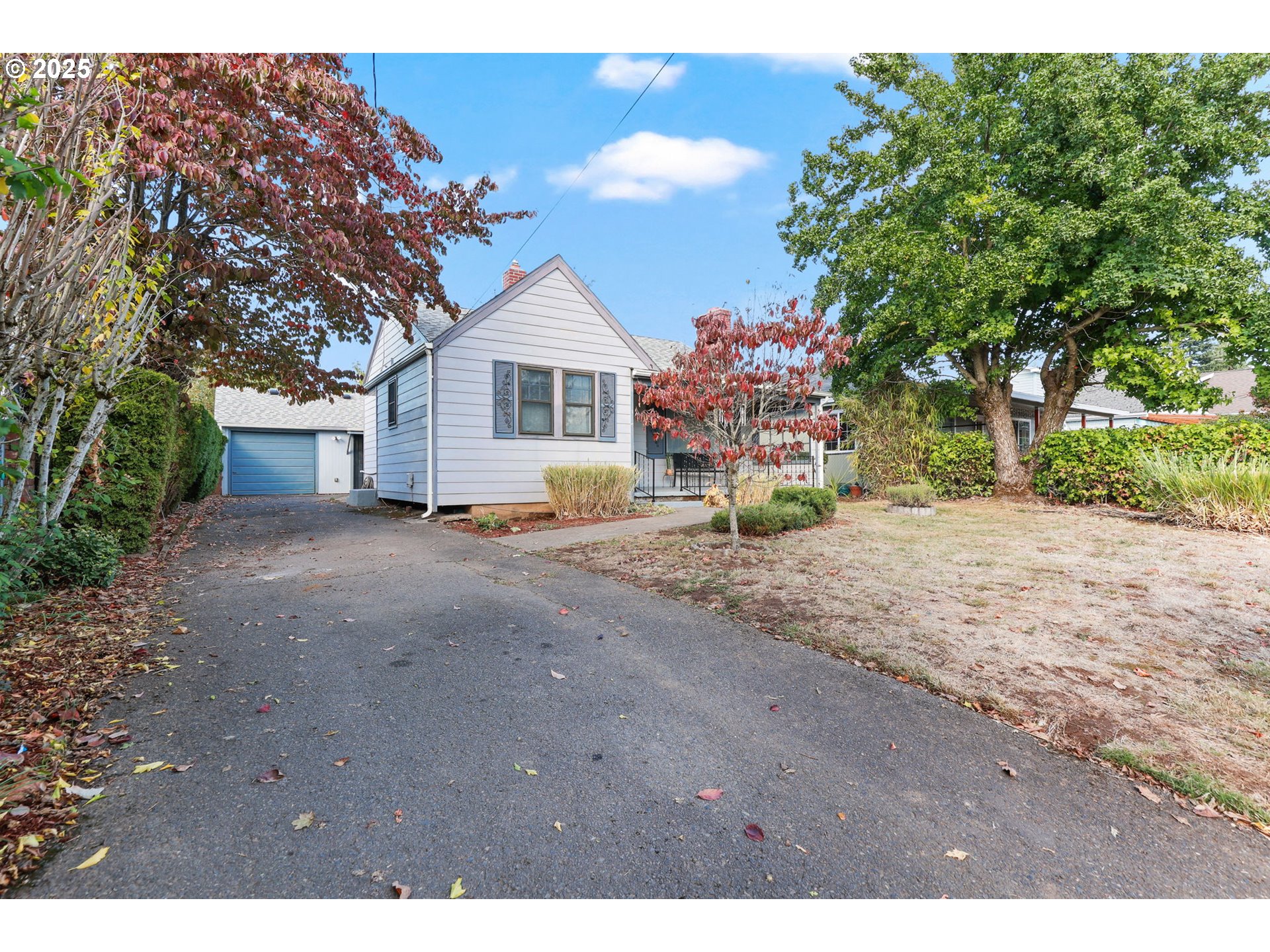 8233 Northeast Tillamook Street Portland, OR 97220 - Photo 4 of 46 a view of a house with a small yard and a large tree