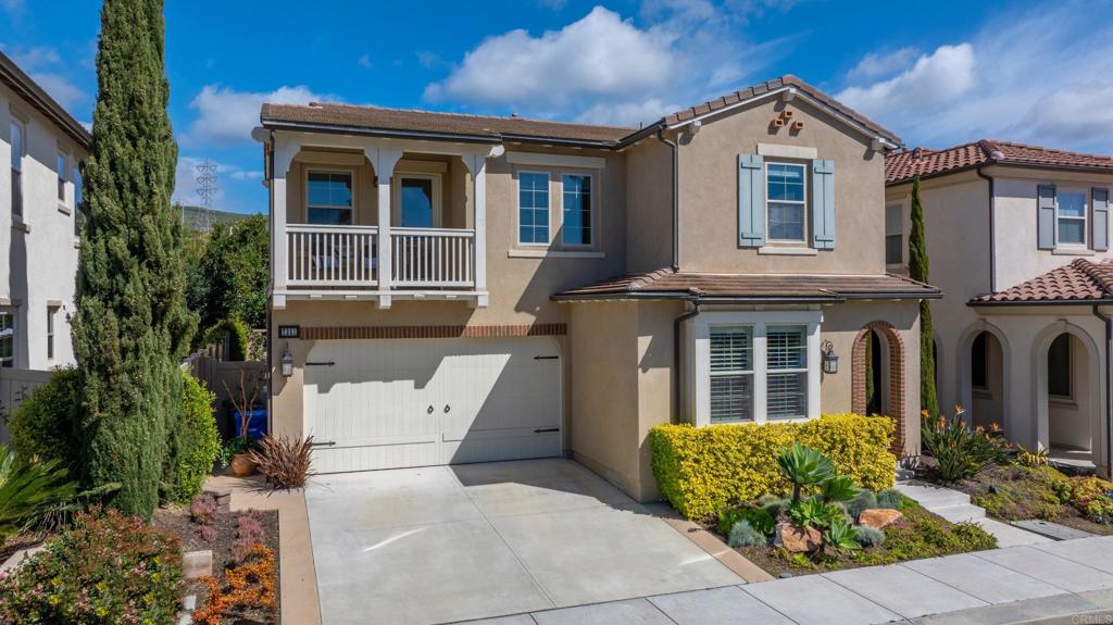 a view of a brick house with large windows and plants