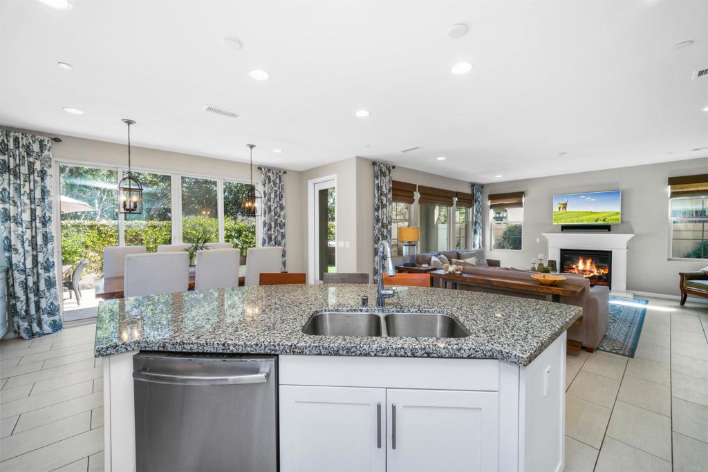 7351 Circulo Ronda Carlsbad, CA 92009 - Photo 11 of 37 a kitchen with granite countertop kitchen island a sink and a counter space