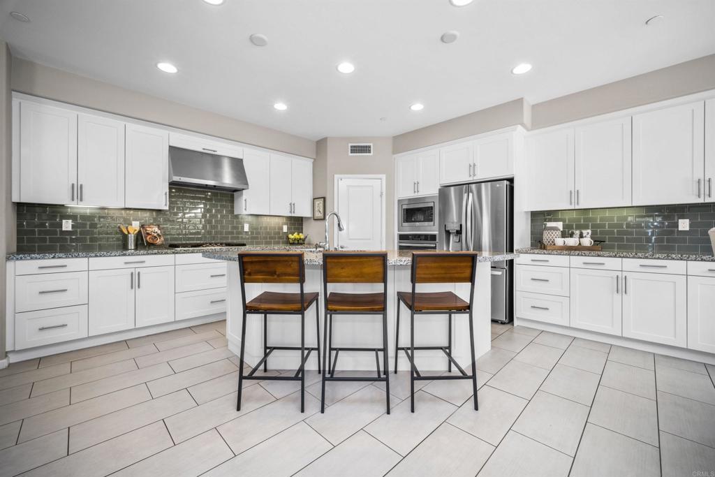 7351 Circulo Ronda Carlsbad, CA 92009 - Photo 12 of 37 a kitchen with white cabinets and white appliances