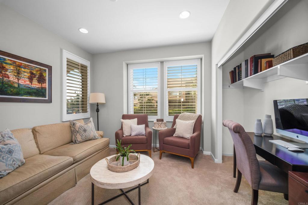 7351 Circulo Ronda Carlsbad, CA 92009 - Photo 16 of 37 a living room with furniture a flat screen tv and a fireplace