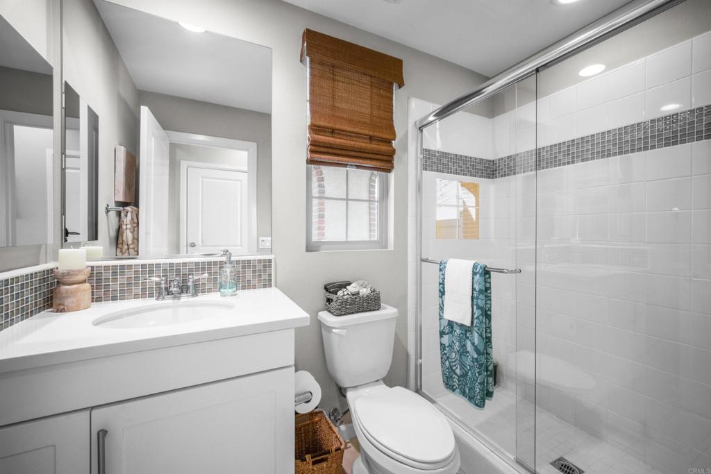 7351 Circulo Ronda Carlsbad, CA 92009 - Photo 17 of 37 a bathroom with a sink toilet mirror and shower