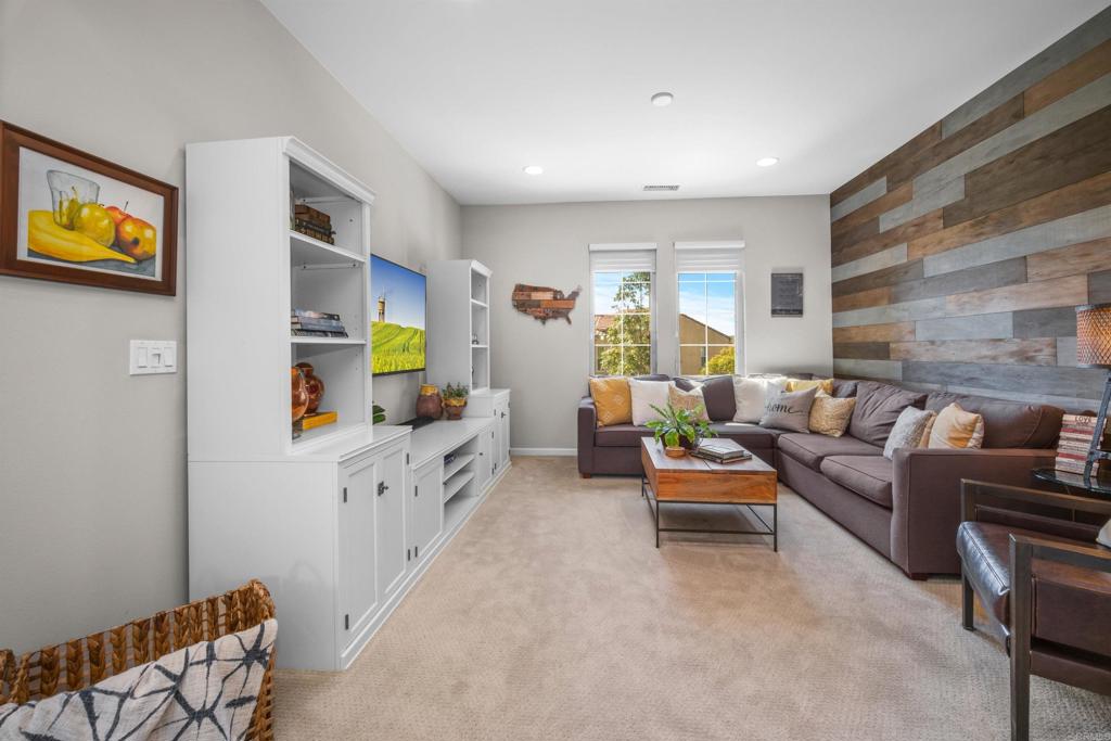7351 Circulo Ronda Carlsbad, CA 92009 - Photo 19 of 37 a living room with furniture and a flat screen tv