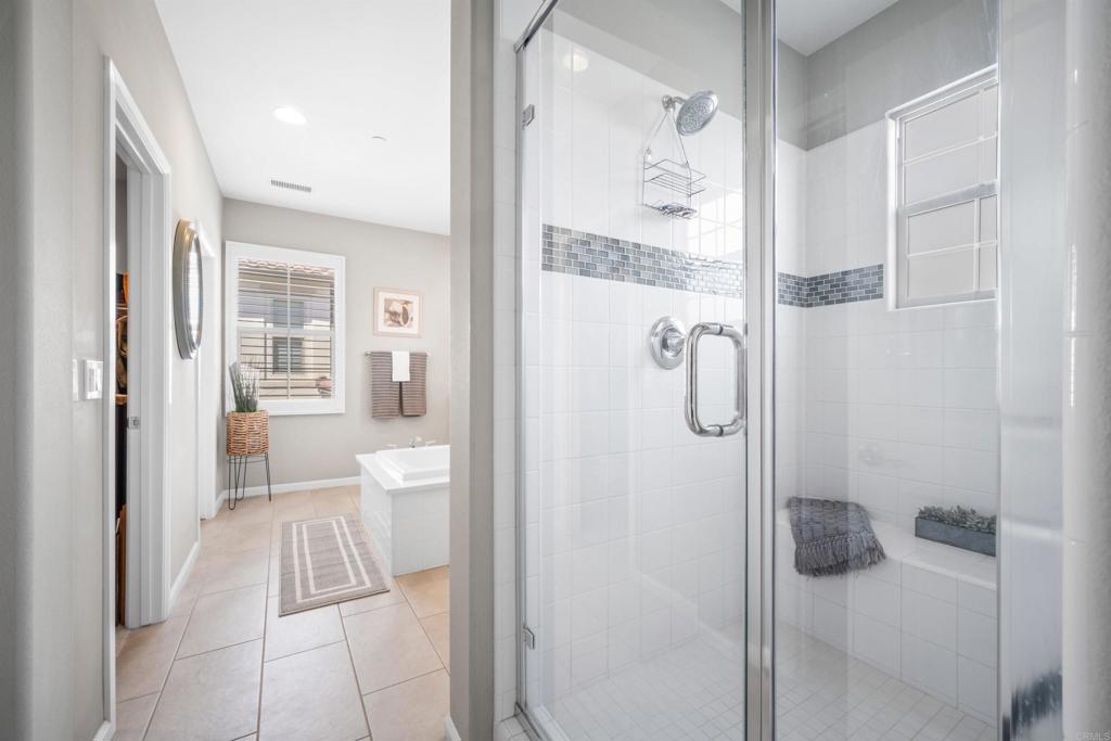 7351 Circulo Ronda Carlsbad, CA 92009 - Photo 22 of 37 a bathroom with a glass shower door
