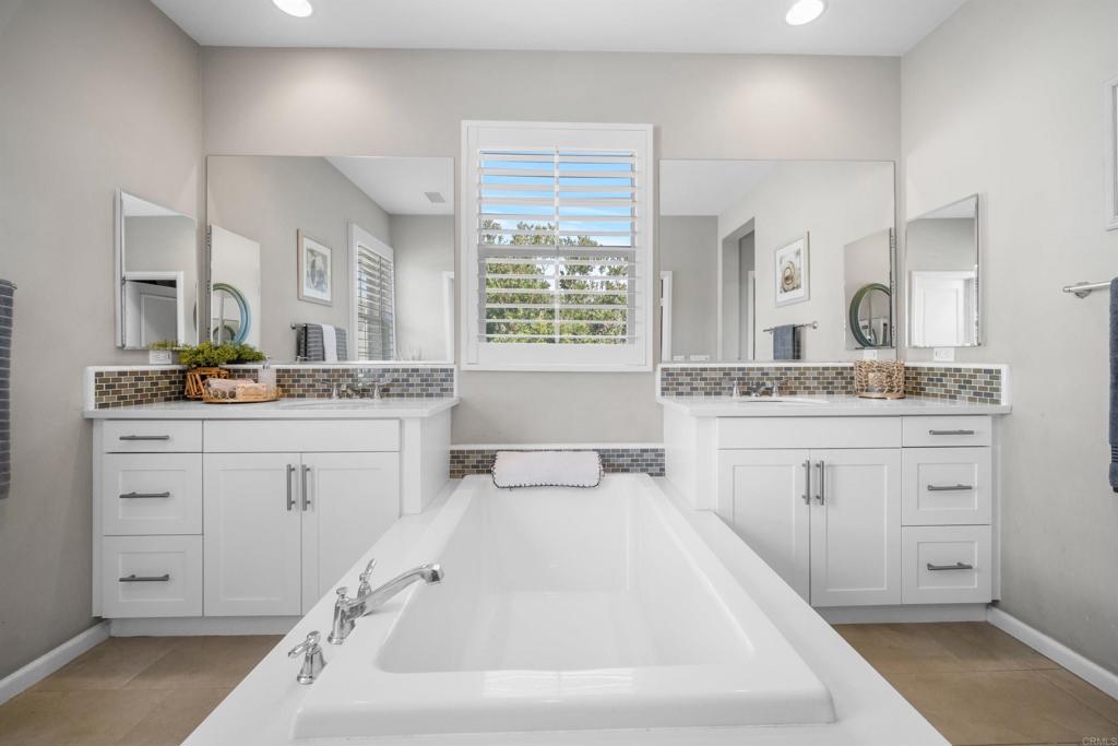 7351 Circulo Ronda Carlsbad, CA 92009 - Photo 23 of 37 a spacious bathroom with a granite countertop sink mirror and a bathtub
