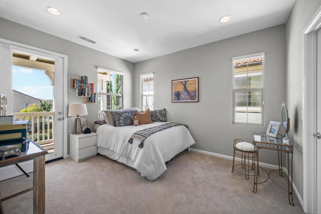 7351 Circulo Ronda Carlsbad, CA 92009 - Photo 24 of 37 a bed room with a bed and a couch