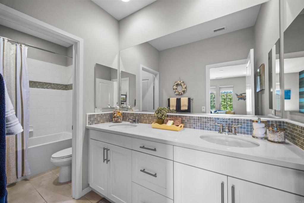 7351 Circulo Ronda Carlsbad, CA 92009 - Photo 26 of 37 a bathroom with a granite countertop sink mirror vanity and toilet