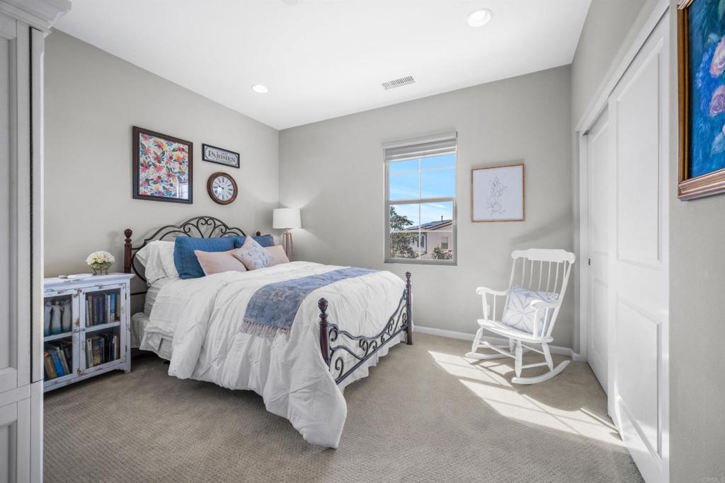 7351 Circulo Ronda Carlsbad, CA 92009 - Photo 27 of 37 a bedroom with a bed chair and painting on the wall