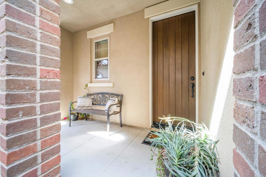7351 Circulo Ronda Carlsbad, CA 92009 - Photo 5 of 37 a living room with furniture and a potted plant
