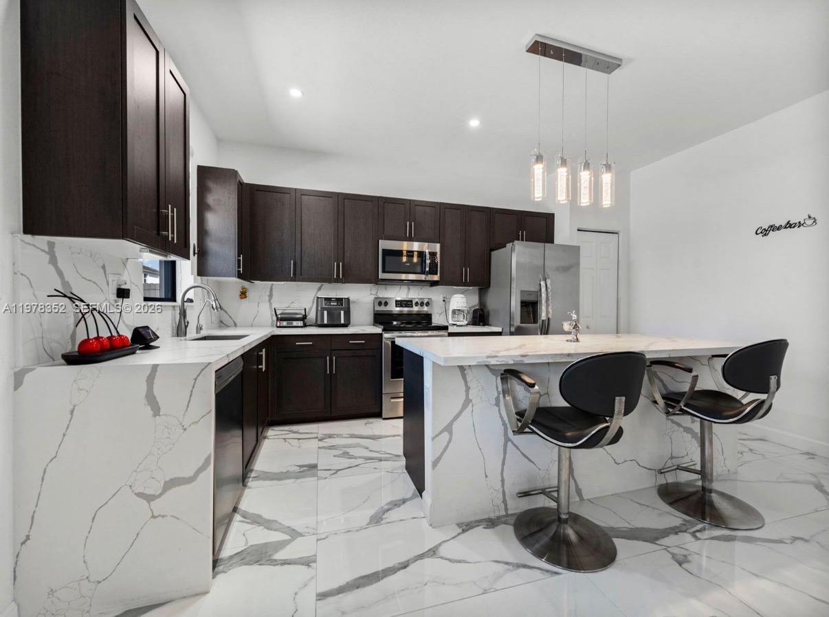 13351 Southwest 190th Street Miami, FL 33177 - Photo 11 of 45 a kitchen with a sink cabinets and window