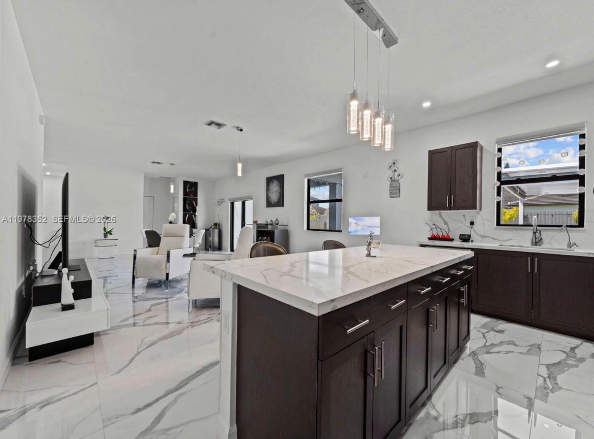 13351 Southwest 190th Street Miami, FL 33177 - Photo 14 of 45 a kitchen with a sink counter top space appliances and cabinets