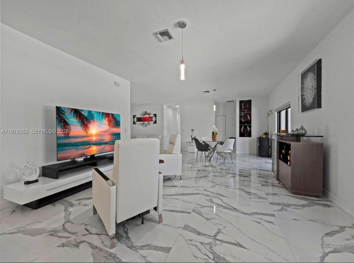 13351 Southwest 190th Street Miami, FL 33177 - Photo 16 of 45 a living room with furniture and a flat screen tv