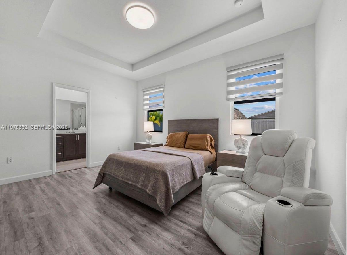 13351 Southwest 190th Street Miami, FL 33177 - Photo 17 of 45 a spacious bedroom with a bed and window