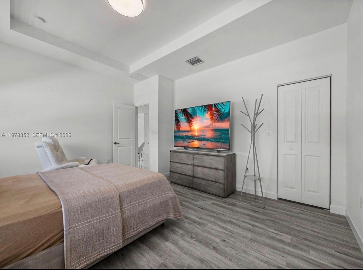 13351 Southwest 190th Street Miami, FL 33177 - Photo 18 of 45 a bedroom with a bed and a flat screen tv