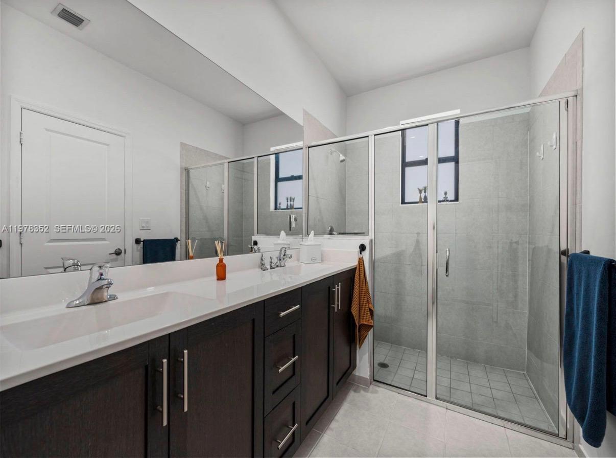 13351 Southwest 190th Street Miami, FL 33177 - Photo 19 of 45 a bathroom with a double vanity sink mirror and shower