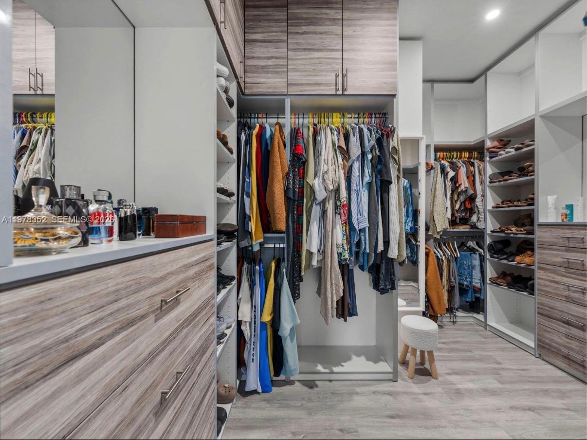13351 Southwest 190th Street Miami, FL 33177 - Photo 22 of 45 a view of walk in closet with clothes