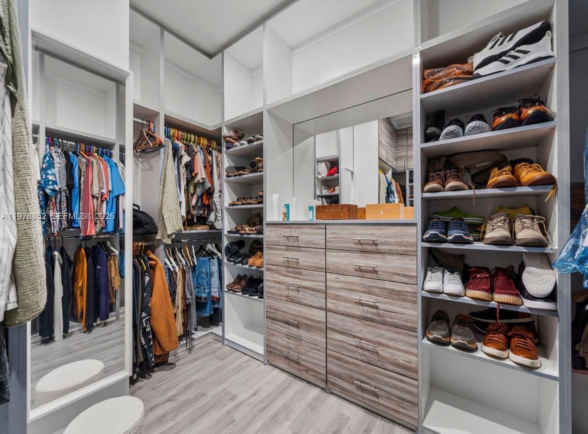 13351 Southwest 190th Street Miami, FL 33177 - Photo 23 of 45 a view of walk in closet with clothes and shoes