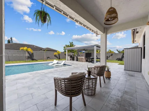 a view of a house with backyard porch and sitting area