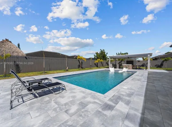 a dining room with furniture and a floor to ceiling window