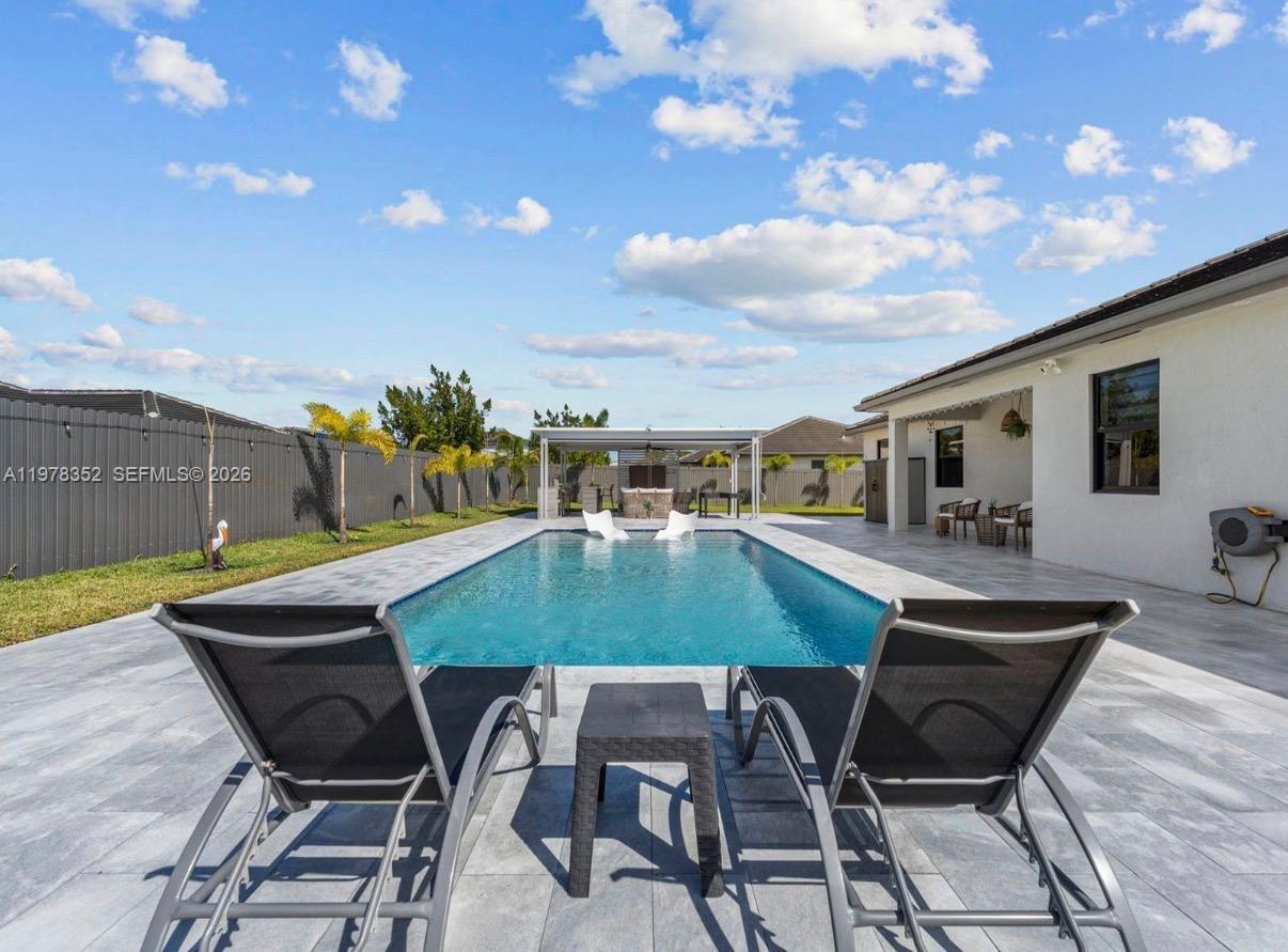 13351 Southwest 190th Street Miami, FL 33177 - Photo 28 of 45 a patio with table and chairs