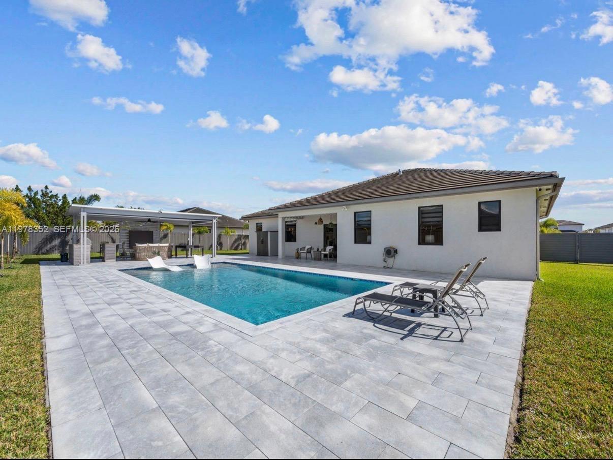 13351 Southwest 190th Street Miami, FL 33177 - Photo 29 of 45 a front view of house with yard and seating