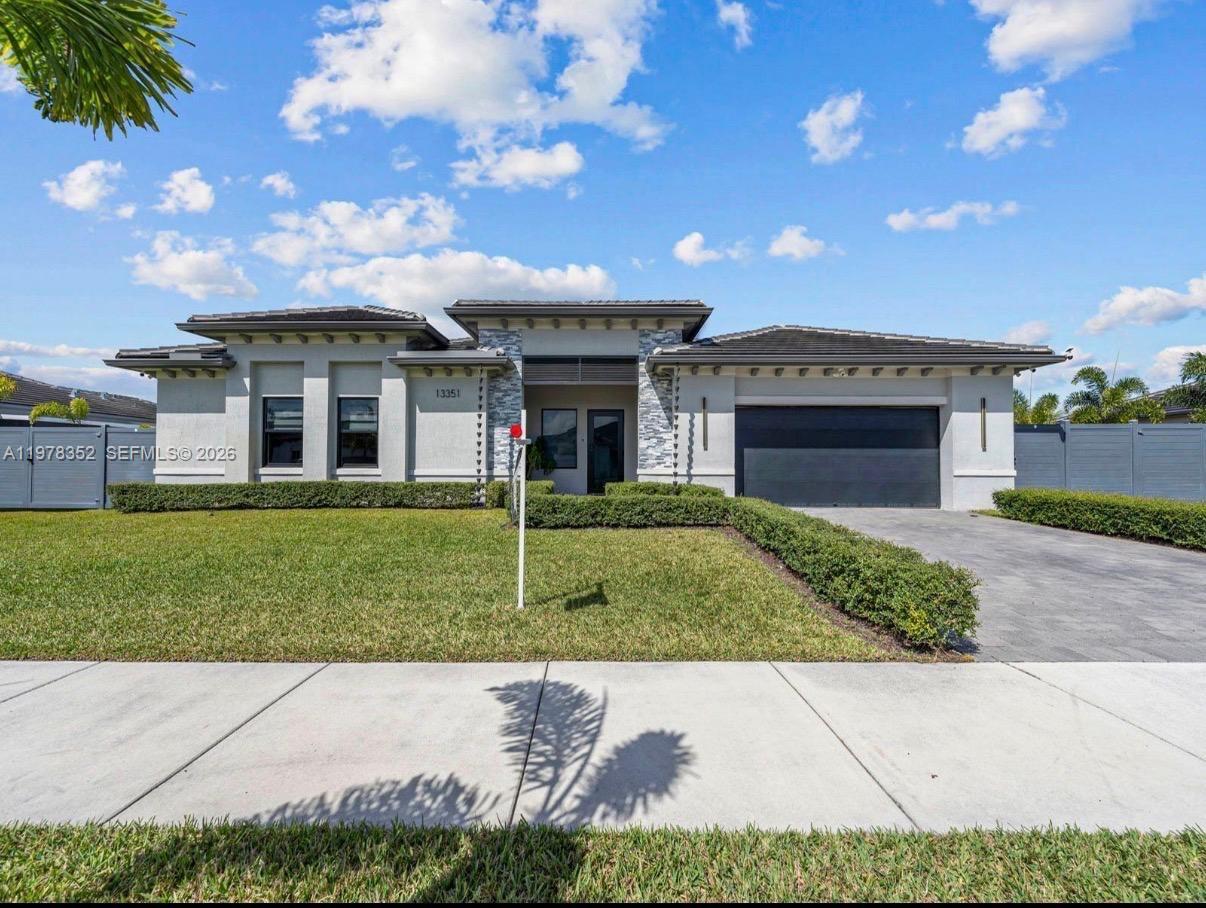 13351 Southwest 190th Street Miami, FL 33177 - Photo 3 of 45 a view of a house with a yard