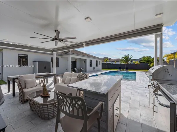 a view of a backyard with sitting area